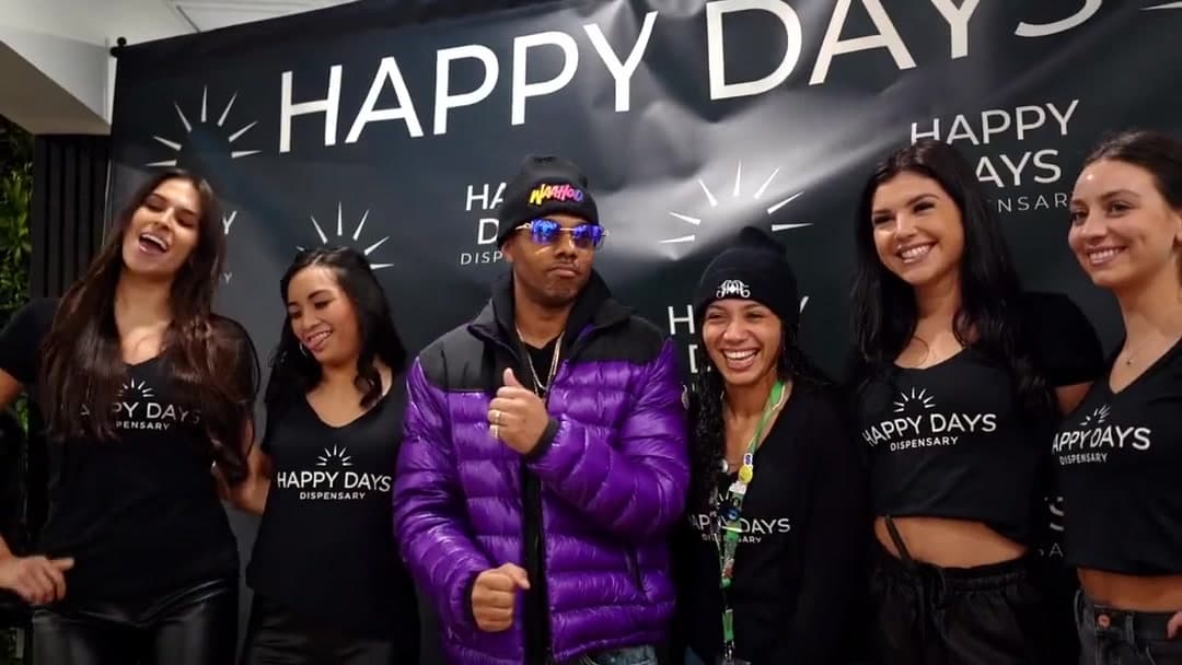 Staff and guests in front of the Happy Days banner on opening day