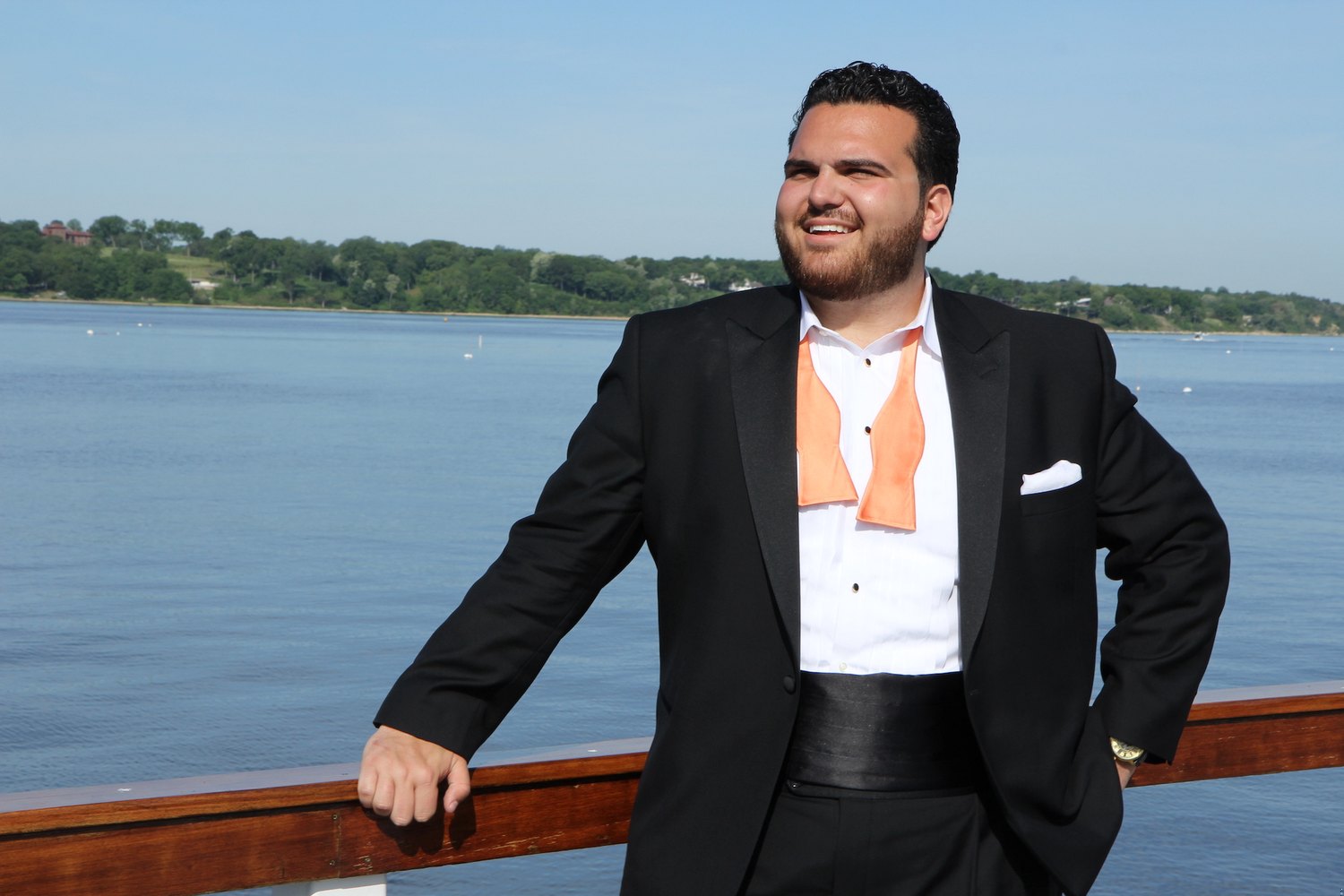 Sal Valentinetti at a harbour railing, boats moored behind him